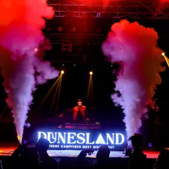 On the decks at Dunesland festival, framed by powerful CO2 jets. I specialize in bringing these high-impact festival effects to any large-scale event.