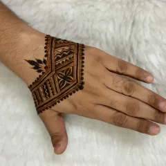 This geometric cuff design is a popular choice for the groom, groomsmen, or the brother of the bride. It's a strong, stylish pattern that covers the back of the hand without being overly floral.