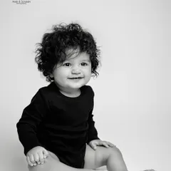 Look at those curls! Sometimes, a simple, classic black and white portrait is all you need to capture the beautiful details of your baby at this age.
