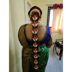 This is an exceptionally detailed floral braid. I used a combination of jasmine, rose petals, and peacock-style floral pieces to create a truly unique and stunning bridal hairstyle.