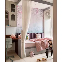 This kids' bedroom is full of playful pastel hues and clever solutions. A single bed with a pullout for playdates is enclosed by sheer curtains with scallop details, creating a cozy canopy.