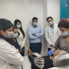 Hands-on training sessions are vital for staying at the forefront of dermatology. Here, I'm observing a procedure with colleagues, always learning and refining our techniques.