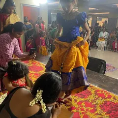 A behind-the-scenes moment from our Saraswati Pooja. Here, a student gets her 'alta' (red dye) applied to her feet, a traditional practice for dancers.