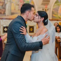 "You may now kiss the bride." A timeless moment captured in a beautiful church setting, sealing the couple's vows with a romantic kiss.