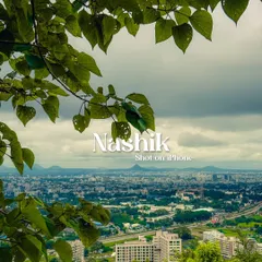 A view of Nashik city, framed by leaves. The text overlay was added to create a simple, elegant postcard from my travels.