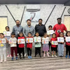 All the proud participants and winners of the coloring competition holding up their completed artwork. It's great to see so many happy faces.