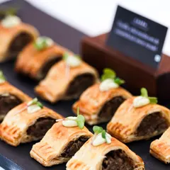 Our lamb and mint sausage rolls are a savory highlight at any event. The flaky puff pastry and flavorful filling make for a perfect high-tea canapé or a satisfying bite at a polo match.