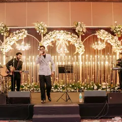 Our stages are designed to be fully functional and beautiful, providing the perfect platform for live entertainment. Here, a band performs against our signature candle wall and floral backdrop, enhancing the overall event experience.