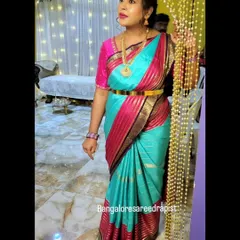 A quick and elegant draping for mom-to-be Arpita. The Mysore silk saree is styled with a waistbelt to accentuate the drape while ensuring she is comfortable during her baby shower.