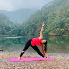 Yoga is a lifelong exploration of the body and mind. Here I am in Trikonasana, or Triangle Pose, by a serene lake, a posture that strengthens the legs and torso while improving balance.