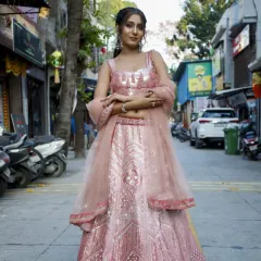 This rose gold and pink lehenga is pure glamour. The intricate sequin work shines from every angle, making it an ideal outfit for a bridesmaid or a wedding guest who wants to stand out.
