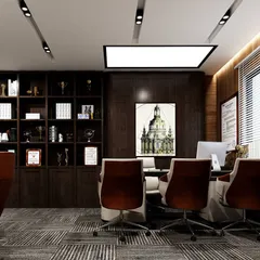 A view of the Managing Director's cabin, designed for both work and meetings. The space includes a large executive desk, comfortable visitor chairs, and extensive built-in shelving for awards and books, all framed by rich wood paneling.