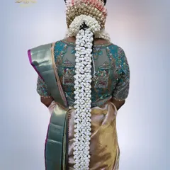 The quintessential South Indian bridal hairstyle. This full Poola Jada, created entirely with fragrant jasmine buds (malli poo), is a breathtaking and traditional choice for any bride.