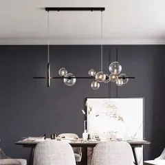 Perfect for a contemporary dining room, this linear chandelier features a series of bubble glass globes along a sleek black bar. It provides excellent task lighting over a long table while adding a touch of modern elegance and visual interest.