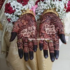I love weaving your story into the mehendi. This design features the phrase 'Qubool Hai' and the wedding date, making it a beautiful and personal memory of the special day.