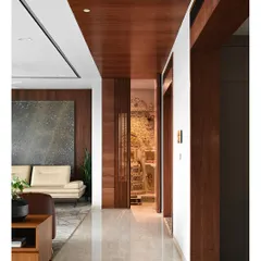 With the doors open, the intricately carved traditional temple is revealed, creating a stunning contrast with the modern lines of the corridor.