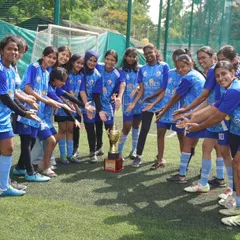The team gathers around the runners-up trophy, a symbol of their fantastic performance, teamwork, and determination throughout the tournament.