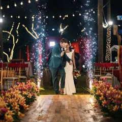 A grand entrance for a fun-loving couple. The aisle is lit up with a line of cold pyrotechnics, creating an electrifying path for their reception entry and getting the party started.