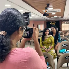 Our students learn not just how to apply makeup, but also how to photograph it. Here, a student is practicing with a professional camera during our photography session.