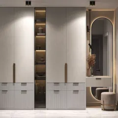 My custom wardrobes are designed for both beauty and function. This unit combines closed storage, glass display shelves with internal lighting, and a dedicated dressing table with a backlit mirror.