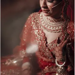 A close-up, artistic portrait of the bride, her eyes full of dreams. The soft focus and warm lighting create a sense of intimacy and timeless beauty.