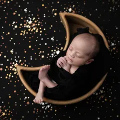 Another perspective of the starry night theme, this image captures the baby's peaceful slumber as he floats in a galaxy of golden stars.