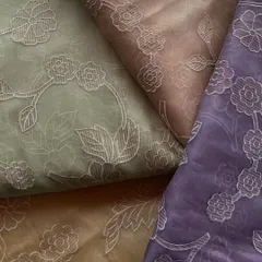 This image shows the beautiful color variations available in my embroidered organza collection. From earthy greens and browns to a deep lavender, each fabric features the same delicate floral outline embroidery for a cohesive yet distinct look.