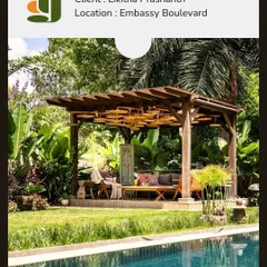 A poolside gazebo designed for a client at Embassy Boulevard. The structure is nestled among tropical foliage, creating a shaded, resort-like lounge area perfect for relaxation.