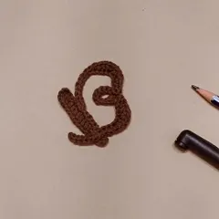 Bold and Beautiful. Here is the letter 'B' in the crochet calligraphy series, shown in a lovely brown color.