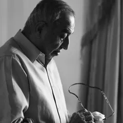 A quiet, candid portrait of the late dance legend Padma Shri Astad Deboo. In this monochrome image, he is seen in a moment of reflection, his life's work and passion etched in his focused expression.