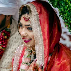 A beautiful profile shot of the bride during the ceremony. The soft light highlights her smile and the traditional details of her Nikah attire.