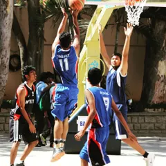 A throwback to my college basketball days in 2014, going up for a layup in a competitive game. These are the moments that fueled my passion for sports performance.