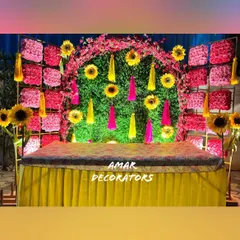 A Mehendi ceremony should be full of joy and color. This setup features a vibrant backdrop of sunflowers and pink florals against a green wall, creating a cheerful and picture-perfect spot for the bride.
