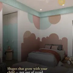 Shapes that grow with your child, not out of trend. This bedroom features a unique, cloud-like headboard and wall decals in a muted color palette, creating a timeless and imaginative space.