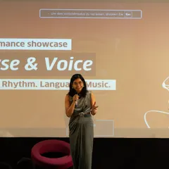 Our founder, Saumya Choudhury, hosting the 'Verse & Voice' performance showcase. We provide a professional platform for our students to present their work to a live audience.