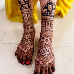 Your bridal look isn't complete without beautiful mehendi on your feet. This design features full coverage with intricate jaali work and delicate lotus flowers, ensuring you look stunning from head to toe on your big day.