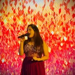 Singing my heart out against a fiery LED backdrop. Sometimes, an event calls for more than just hosting.