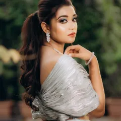 A graceful portrait of the bride looking over her shoulder. Her pose is elegant, and the soft background helps to make her the complete focus of the image.