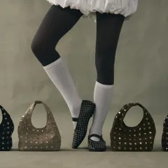 My signature studded edit, featuring ballet flats and cutout bags. This look is about coordinated edge, where the repetition of the silver rivets creates a cohesive and powerful style statement.