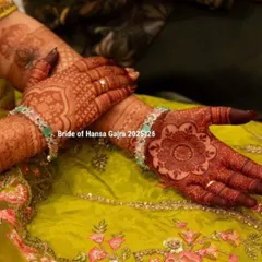 A close-up of a colored mehendi design. The floral mandala on the palm is enhanced with color, making the pattern pop and creating a vibrant, eye-catching look.