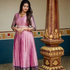 A full-length view showcasing the elegant drape of the upcycled saree gown. The waistband cinches the silhouette, while the original border provides a weighted hem that gives the skirt a beautiful shape.