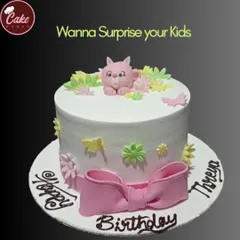 A sweet and simple birthday cake with a cute pink cat, flowers, and a large pink bow. It's a charming design perfect for surprising your kids.