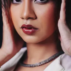 An intense close-up that brings attention to the model's makeup and expression, adding a touch of editorial flair to a fashion shoot.