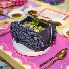 Why just carry a handbag when you can eat one? For a luxury fashion event, we created this playful salad served in an edible, blueberry-studded purse. It’s this blend of high fashion and culinary wit that defines our approach.