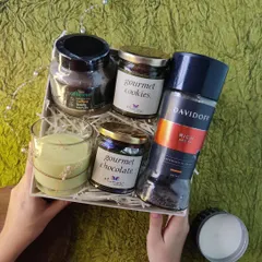The 'Take It Easy' box is designed for ultimate relaxation. This self-care hamper includes Davidoff coffee, a coffee body scrub, gourmet treats, and a scented candle to help anyone unwind.