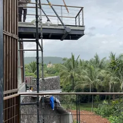 A view from the nearly completed cantilevered balcony at our Karjat project. The structure is designed to frame the stunning panorama of the valley, making the natural scenery an integral part of the living experience.