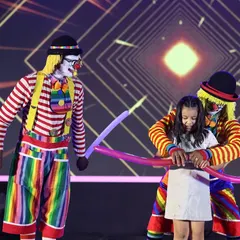 Nothing brings more joy to a child's face than our interactive clown acts. Here, our performers engage directly with a young audience member, creating a special and memorable moment with fun balloon props.