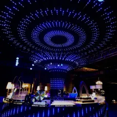 I transform Sangeet nights into immersive experiences. Here, a custom-designed ceiling of concentric LED rings creates a mesmerizing starry sky effect over the central bar, setting a futuristic and high-energy techno vibe for the party.