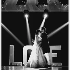 The same iconic "LOVE" sign shot, showcasing the couple's intimate moment. We design these picture-perfect spots for memories that will last a lifetime.