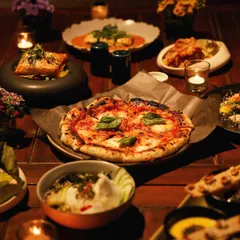 Our artisanal pizzas are a highlight of the evening menu, crafted with high-quality ingredients and baked to perfection.